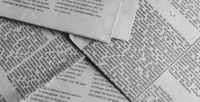 Close-up of newspapers with articles on fluoropolymers and plastics industry trends.