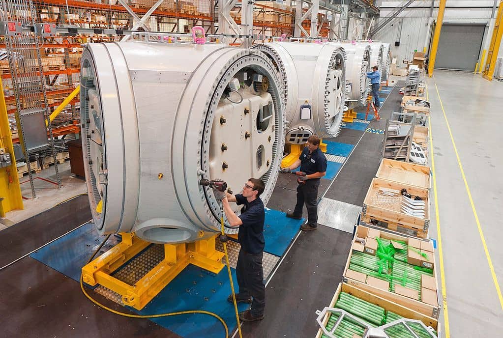 Industrial manufacturing of large plastic components in a factory setting.