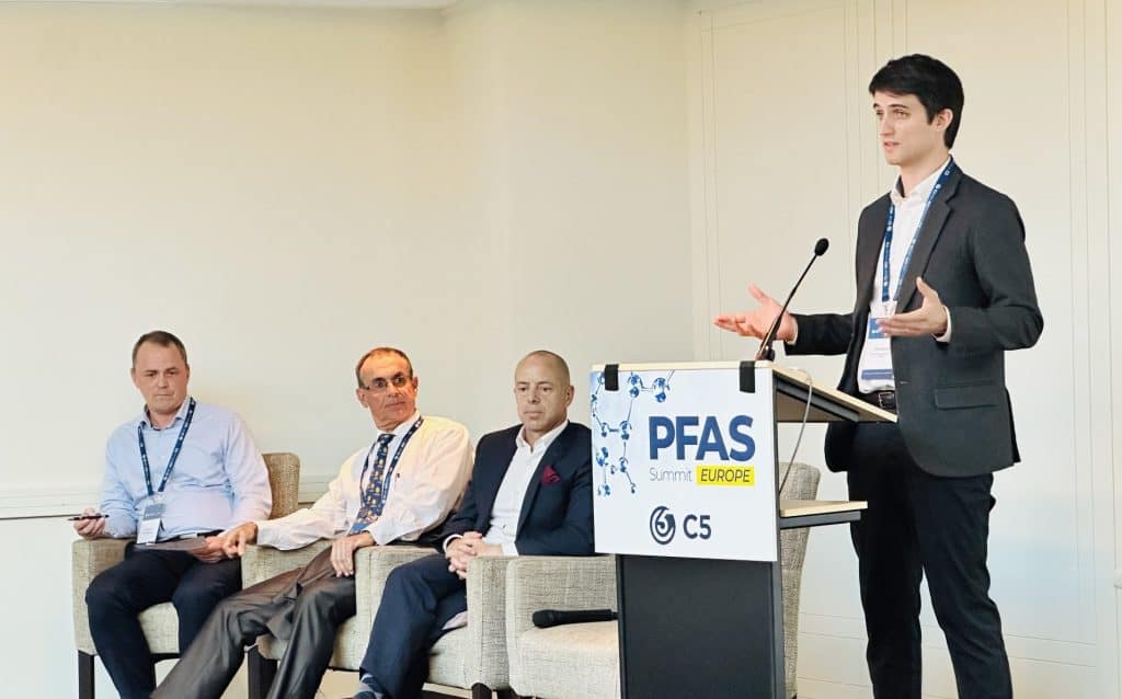 Young professional speaking at PFAS Summit Europe about plastics and fluoropolymers.